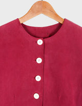 a woman is wearing a 90s burgundy shirt.