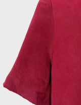 a woman is wearing a 90s burgundy shirt.