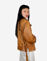 a woman is wearing a brown leather jacket.