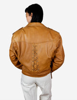 a woman is wearing a brown leather jacket.