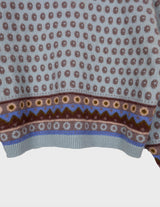 a woman is wearing a light blue vintage sweater.