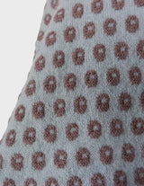 a woman is wearing a light blue vintage sweater.