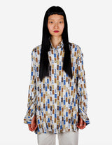 a woman is wearing a arty look blouse.