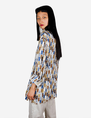 a woman is wearing a arty look blouse.
