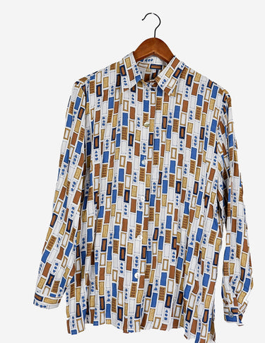 a woman is wearing a arty look blouse.