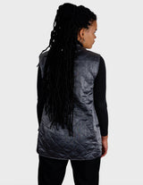 a woman is wearing a silver quilted vest.