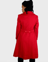 a woman is wearing a 90s vintage red coat.