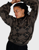 a woman is wearing a 80s brown vintage abstract pattern sweater.