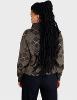 a woman is wearing a 80s brown vintage abstract pattern sweater.