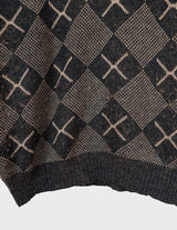 a woman is wearing a 80s brown vintage abstract pattern sweater.