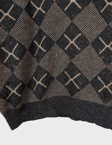 a woman is wearing a 80s brown vintage abstract pattern sweater.