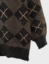 a woman is wearing a 80s brown vintage abstract pattern sweater.