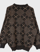 a woman is wearing a 80s brown vintage abstract pattern sweater.