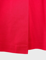 a woman is wearing a 90s vintage red coat.