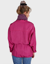 a blonde woman is wearing a 80s vintage silk jacket.