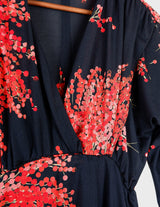 a woman with blonde hair is wearing a vintage 80s 90s floral maxi dress.