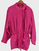 a blonde woman is wearing a 80s vintage silk jacket.