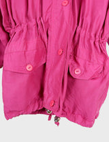a blonde woman is wearing a 80s vintage silk jacket.