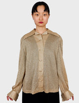 a woman is wearing a glitter blouse.