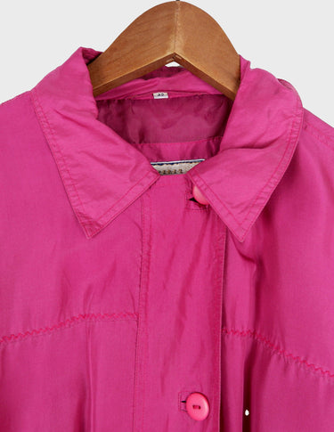 a blonde woman is wearing a 80s vintage silk jacket.
