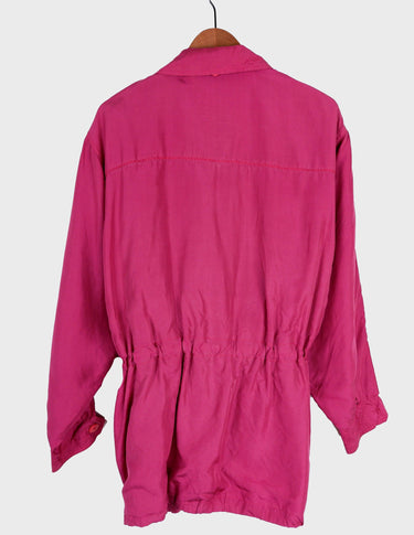 a blonde woman is wearing a 80s vintage silk jacket.