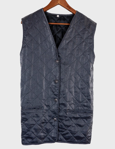 a woman is wearing a silver quilted vest.