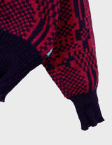 a woman is wearing a 80s dark pink geometric turtleneck sweater.