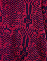 a woman is wearing a 80s dark pink geometric turtleneck sweater.