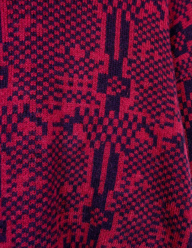 a woman is wearing a 80s dark pink geometric turtleneck sweater.
