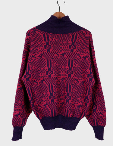 a woman is wearing a 80s dark pink geometric turtleneck sweater.