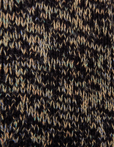 a woman is wearing a brown sweater.