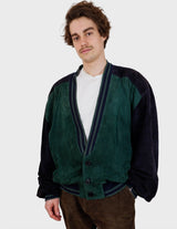 a man is wearing a 80s vintage green jacket.