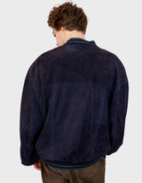 a man is wearing a 80s vintage green jacket.