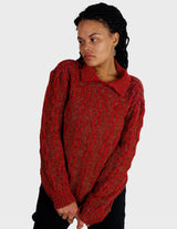 a woman isi wearing a vintage 90s cable knit sweater.