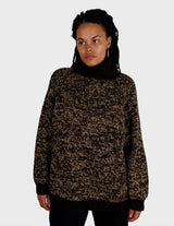 a woman is wearing a brown sweater.