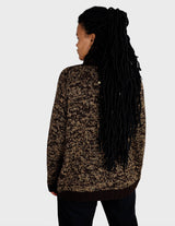 a woman is wearing a brown sweater.