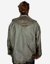 a woman is wearing a olive green jacket.