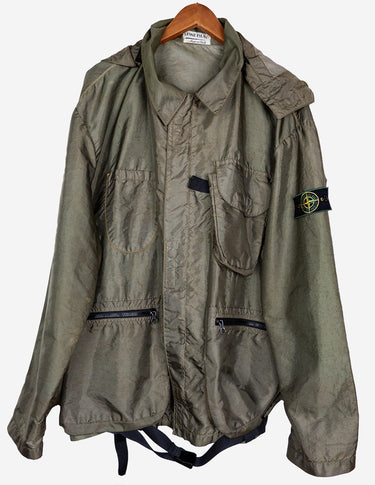 a woman is wearing a olive green jacket.
