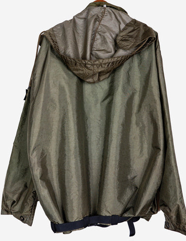 a woman is wearing a olive green jacket.