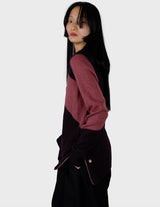 an asian woman is wearing a pink sweater.