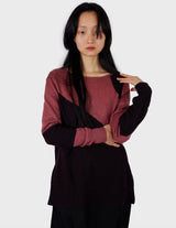 an asian woman is wearing a pink sweater.