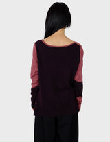 an asian woman is wearing a pink sweater.