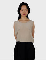 a woman is wearing a beige vintage 90s silk top.