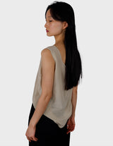 a woman is wearing a beige vintage 90s silk top.