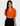 a woman is wearing a vintage 70s 80s orange top.