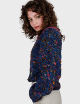 a woman is wearing a handknitted sweater.