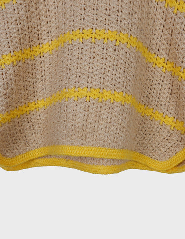 a woman is wearing a vintage 70s handknitted slipover.