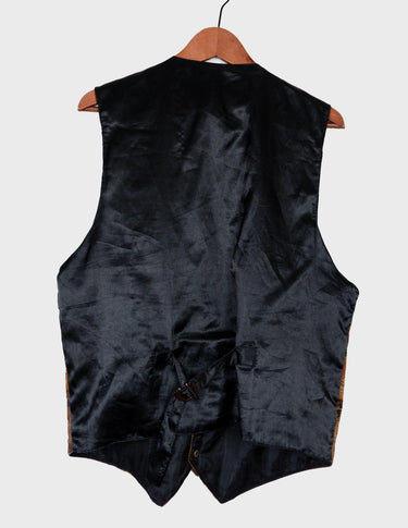 an asian woman is wearing a 90s vintage brown vest with historical pattern.