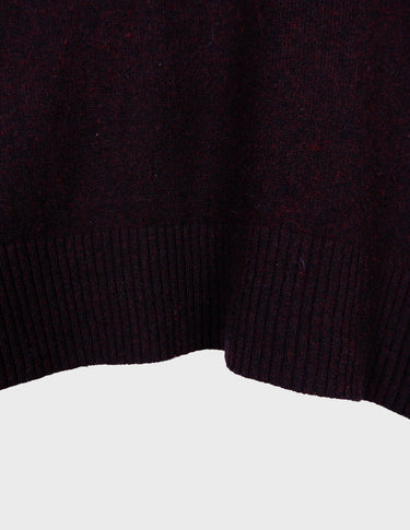 an asian woman is wearing a pink sweater.