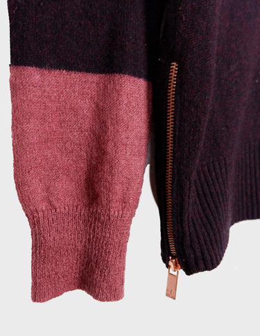 an asian woman is wearing a pink sweater.